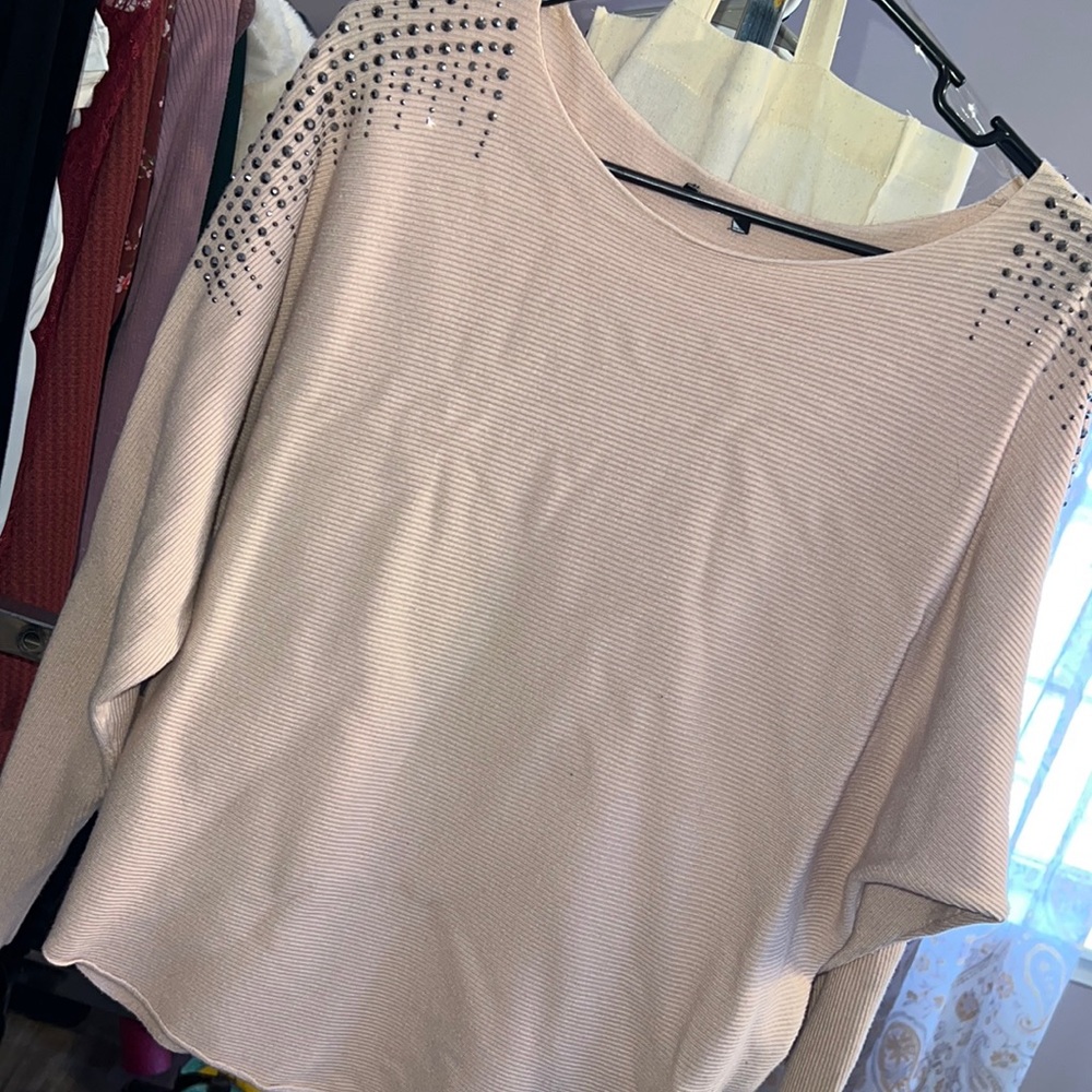 Medium, long sleeve sweater with grey/metallic detail on shoulders